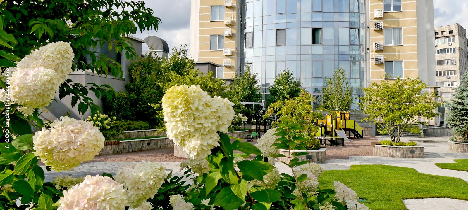 Roof garden with lawn, walkways and raised plant beds